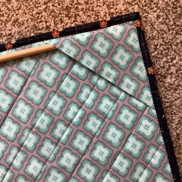 How to Use Corner Triangles to Hang a Quilted Wall Hanging